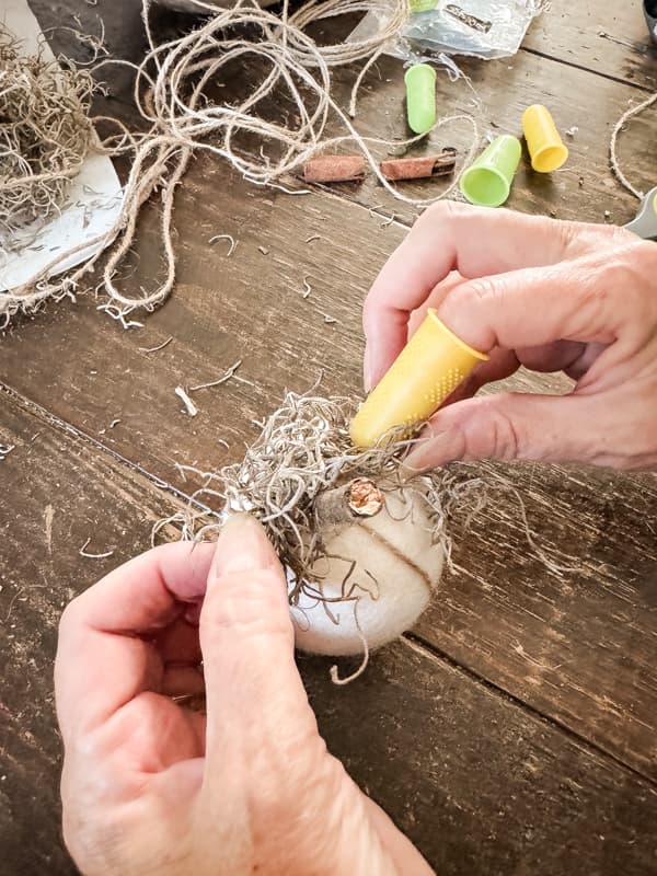 Add spanish moss around the foraged stick stem 