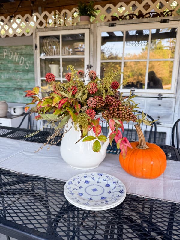 foraged floral arrangement for fall dinner party in outdoor kitchen