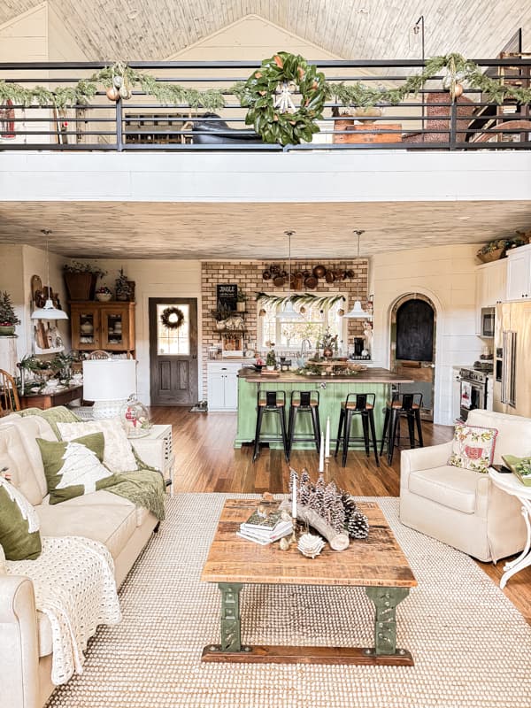 2024 Christmas Farmhouse Home Tour with DIY magnolia wreath and over sized Christmas ornaments on banister.