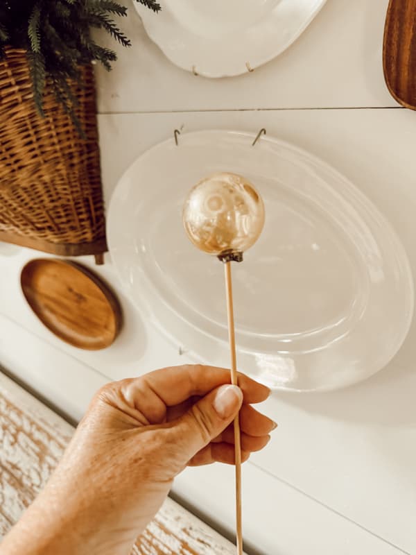 Add glass ornaments to bamboo skewer to add to Christmas arrangement.  