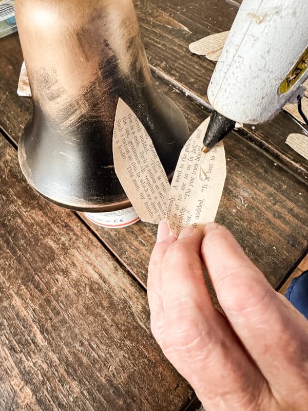 apply the teardrop old book pages petals to the Dollar Tree bells with hot glue.  