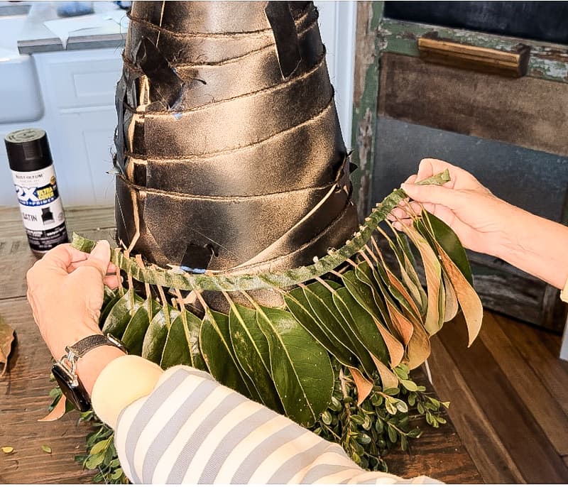 Rows of Magnolia leaves attached with floral tape and hot glue