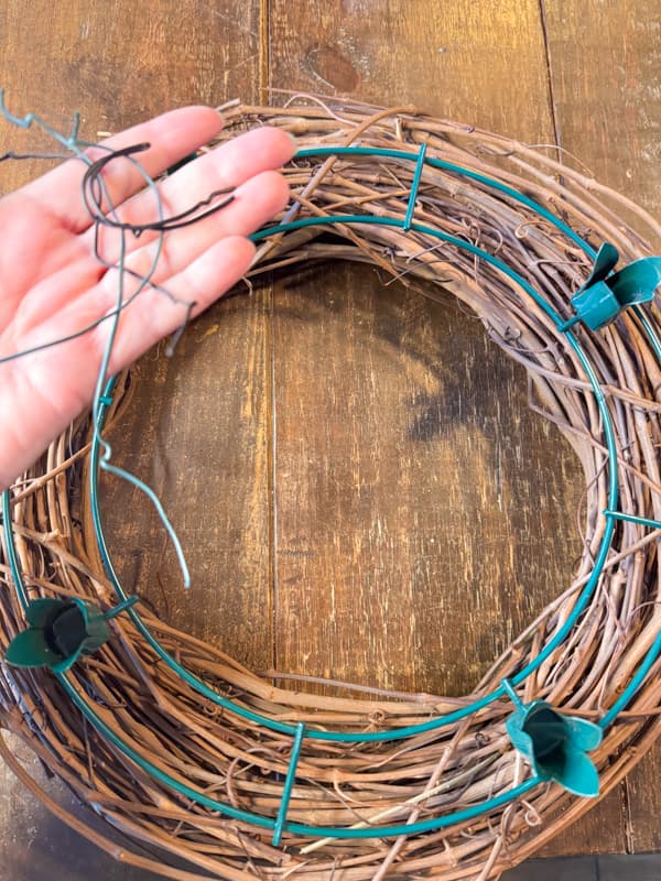 attach the advent wreath frame to the grapevine wreath with wire ties.