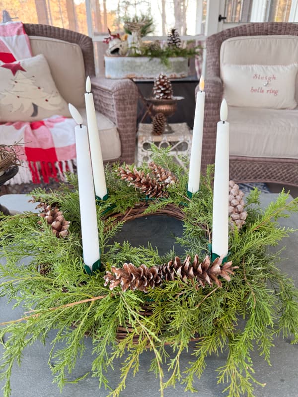 DIY Advent Wreath with flicker candles on screen porch coffee table a pinecone Christmas craft idea