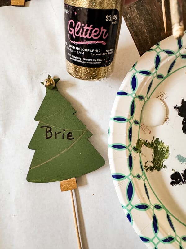 Green Tree Cheese Marker before Adding gold glitter to the wooden Dollar Tree Trees with glue.  