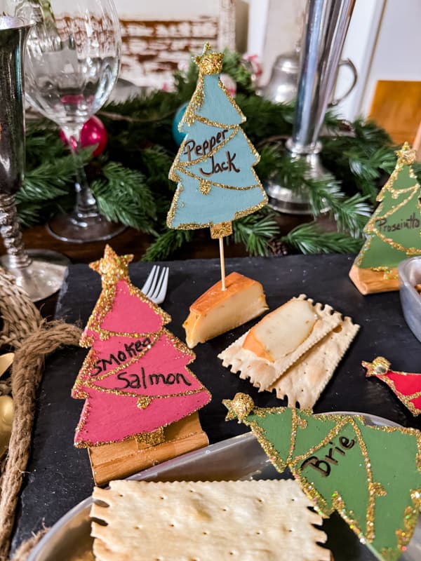 DIY Appetizer Markers made with Dollar Tree Wood Cutouts, paint and glitter.  Blue Pepper Jack marker in cheese