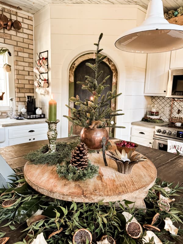 Vintage French Cheese Board with Copper kettle holding a mini christmas tree.  DIY napkin decoupage candlestick holders.