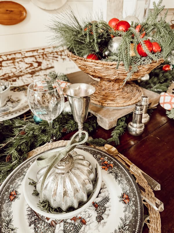 holiday place setting with Christmas plates and white french bowl with mercury glass ornaments.  Basket bowl with shiny brite ornaments.  