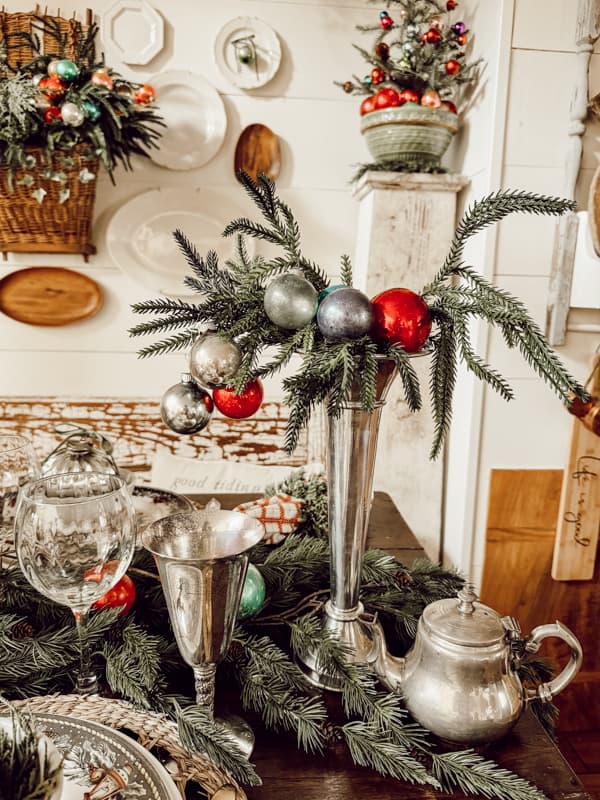 Retro Christmas Decoration ideas with silver fluted vases and vintage glass Christmas ornaments.in dining room. 