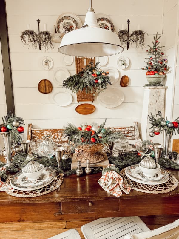 Dining area decorated in retro Christmas style with wall plate gallery and vintage glass ornaments.  