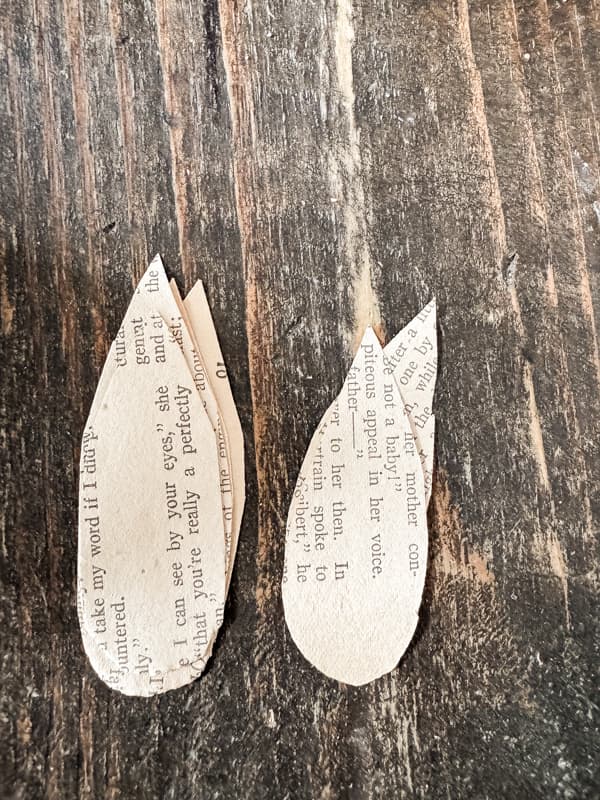 Cut teardrop petals out of old book pages.