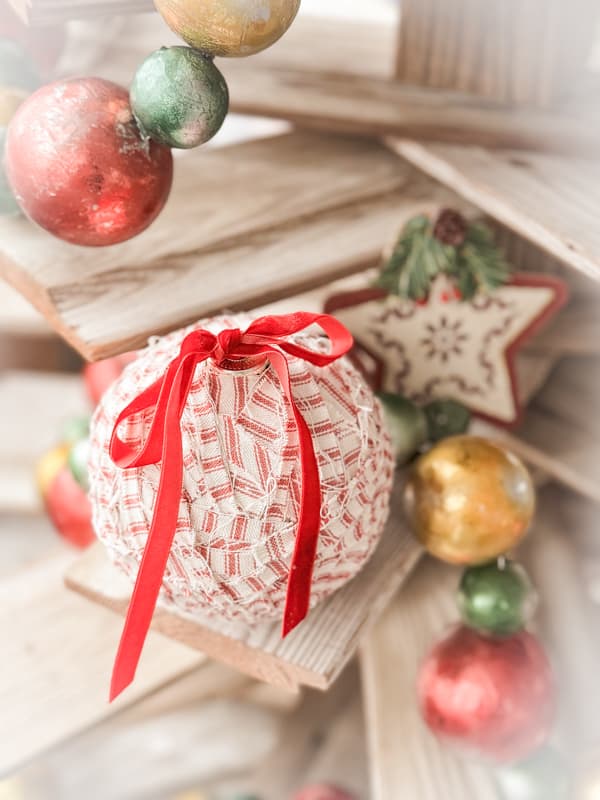 Ticking fabric Christmas Ornament on a shiplap wood tree.