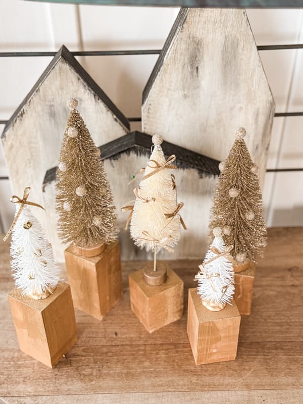 add hot glue to base of trees to add to wooden blocks to enhance inexpensive trees into high end designers style Christmas trees.