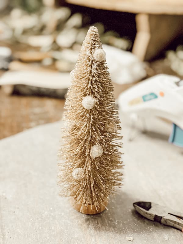 Inexpensive Gold Bottle Brush Tree with gold beads stem added to tree with hot glue.