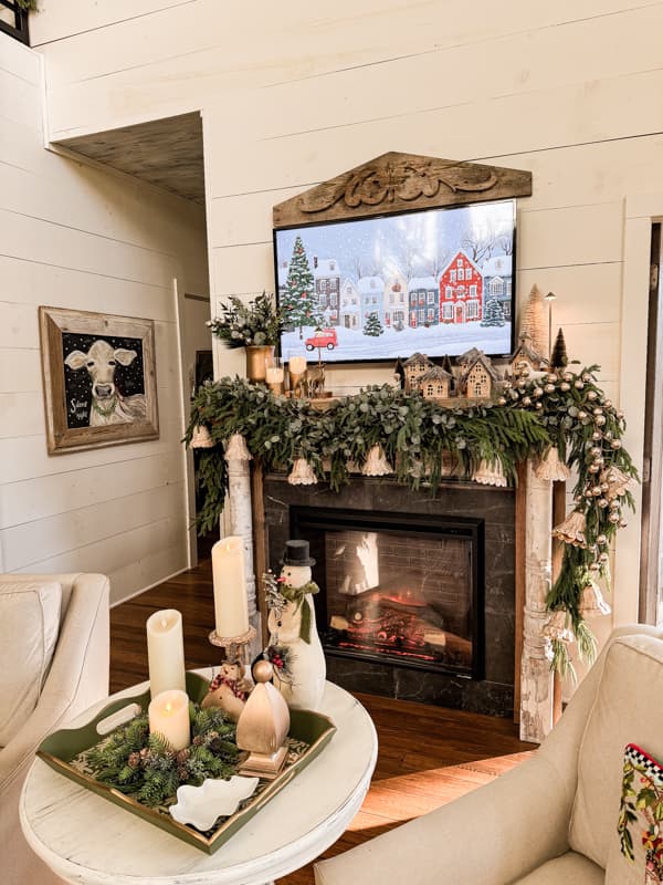 Farmhouse Christmas 2024 Home Tour with mantel decorated with DIY bells, rustic village and gold candle holders.  