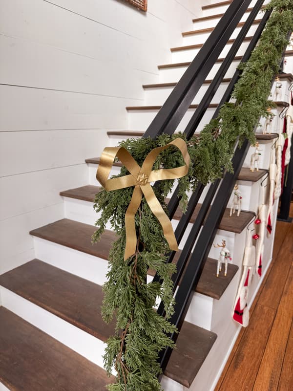 DIY Metal Christmas Bow on Banister Greenery.