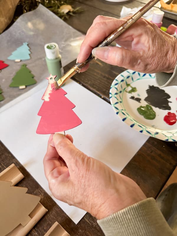 Paint wood cutout Christmas Trees with Pink Craft Paint.