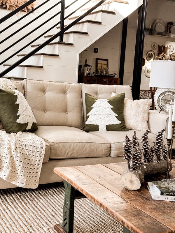 DIY Christmas Tree Pillow Covers on sofa and DIY pinecone Christmas tree centerpiece on coffee table.  