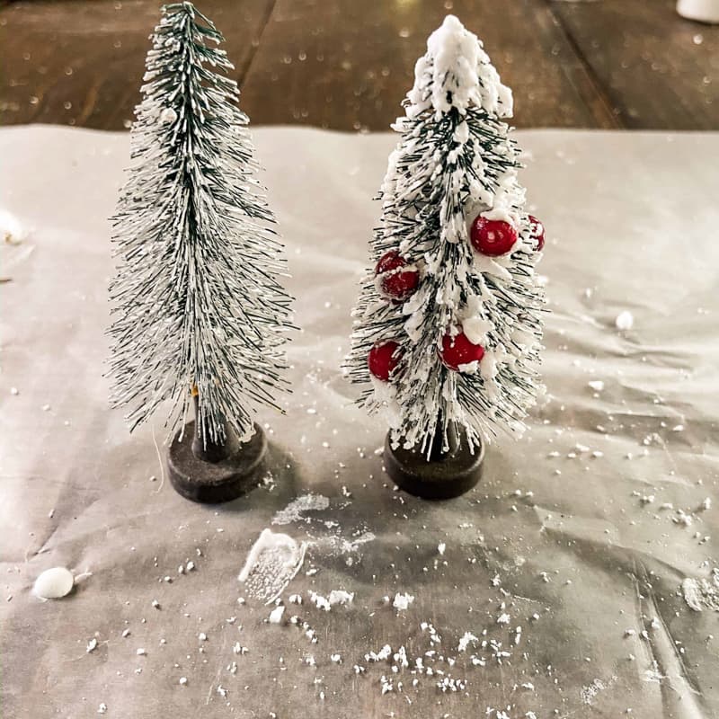 Upcycled Bottle Brush trees with fake snow and red berries.