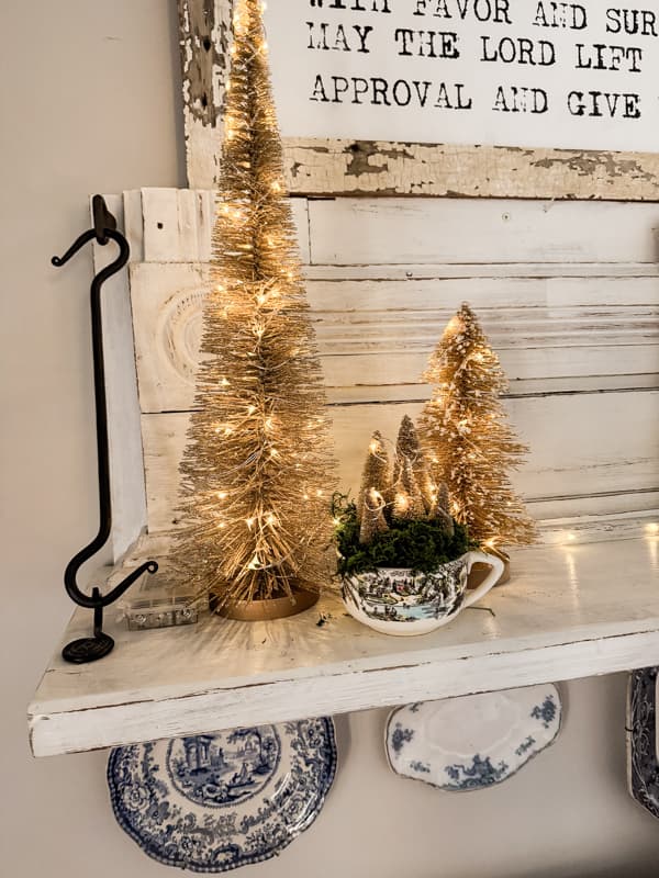 Wrap battery operated fairy lights around existing gold bottle brush trees for a Pottery Barn Style Christmas Decor 