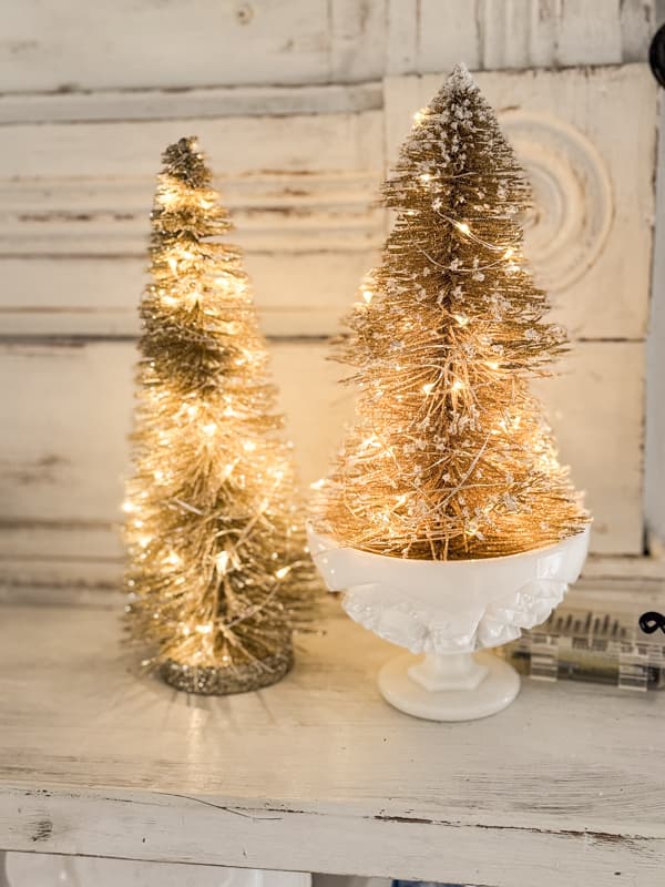 Wrap battery operated fairy lights around existing gold bottle brush trees for a Pottery Barn Style Christmas Decor