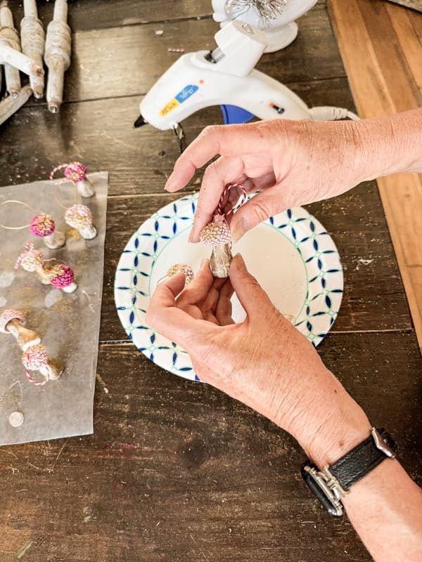 Attach acorn cap to the air dry clay stem for make DIY Mushroom Christmas Ornaments for Acorn Craft