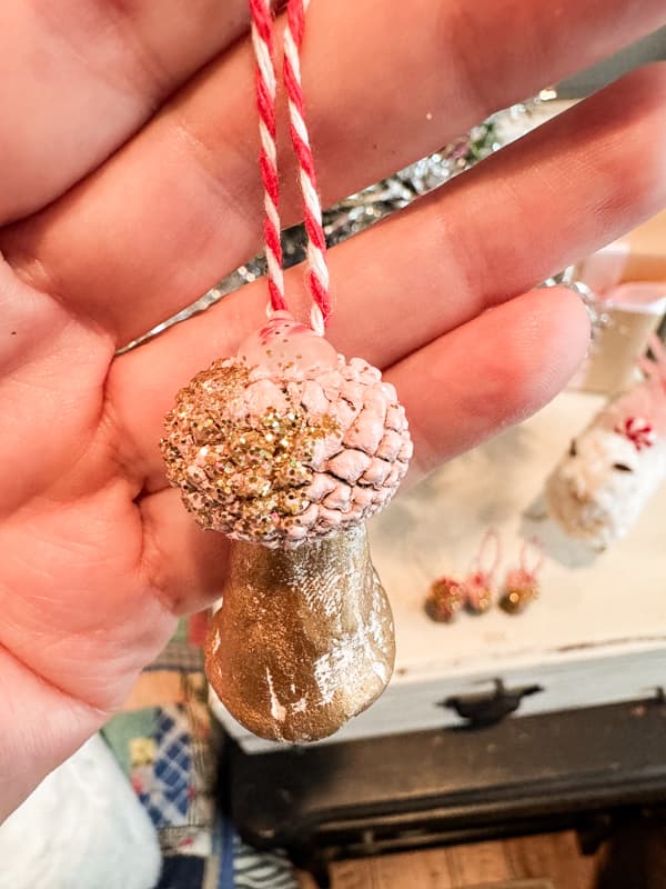 Acorn Craft DIY Mushroom Christmas Ornament with pink acorn cap and bakers twine hanger.