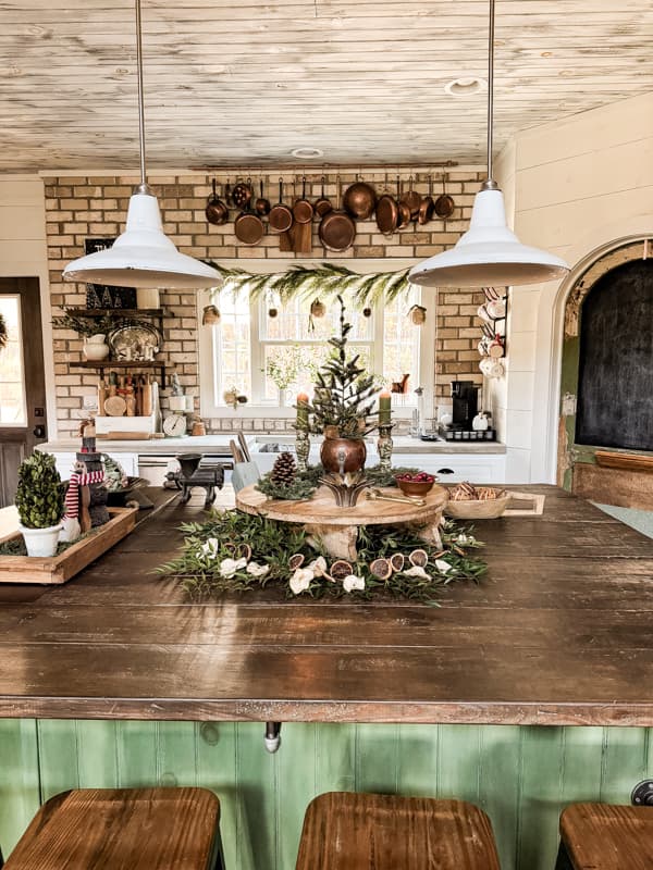 2024 Christmas Farmhouse Tour with Kitchen island centerpiece on a vintage cheese board with vintage copper.