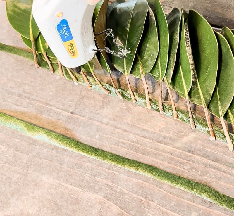 Rows of Magnolia leaves attached with floral tape and hot glue