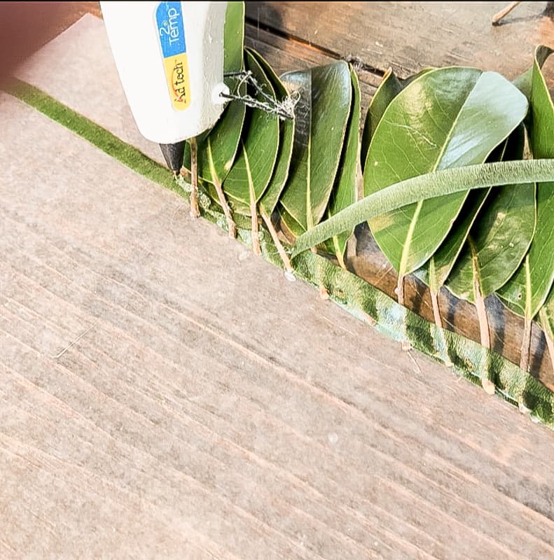 Rows of Magnolia leaves attached with floral tape and hot glue