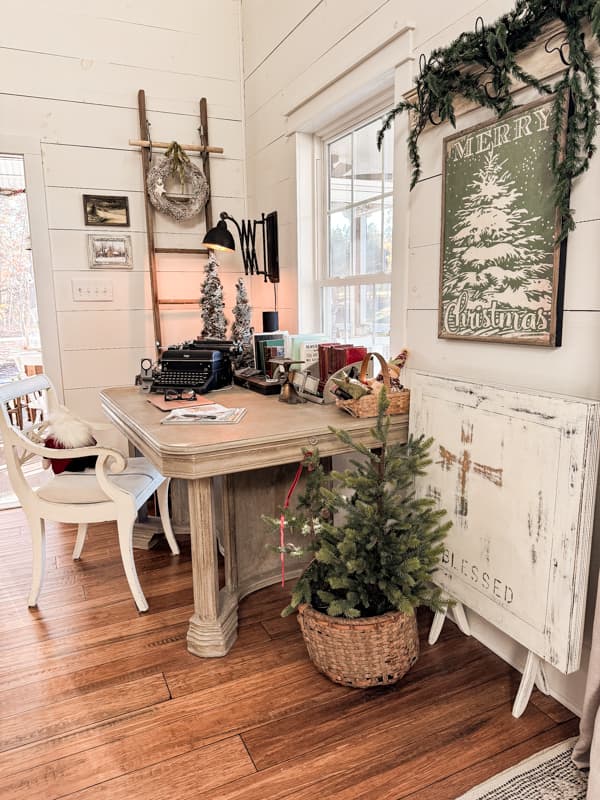 Office desk decorated for Christmas with vintage typewriter and rotary phone.  