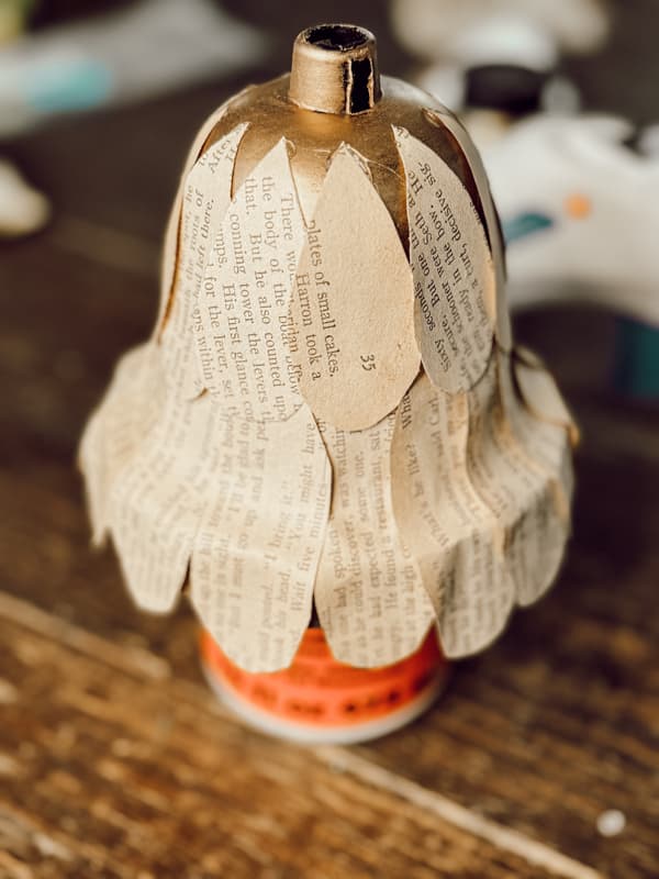 Covered Dollar Tree Bell with Old Book Pages for DIY Christmas Bells.