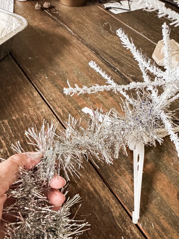 Wrap silver tinsel around the bare tree branches to make a Vintage tinsel tree.