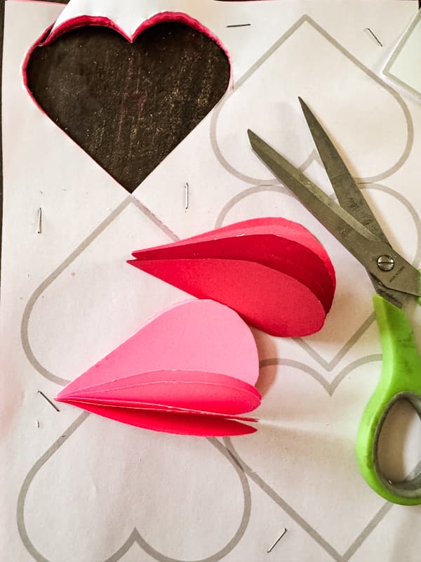 Cut several paper hearts at one time with scissors