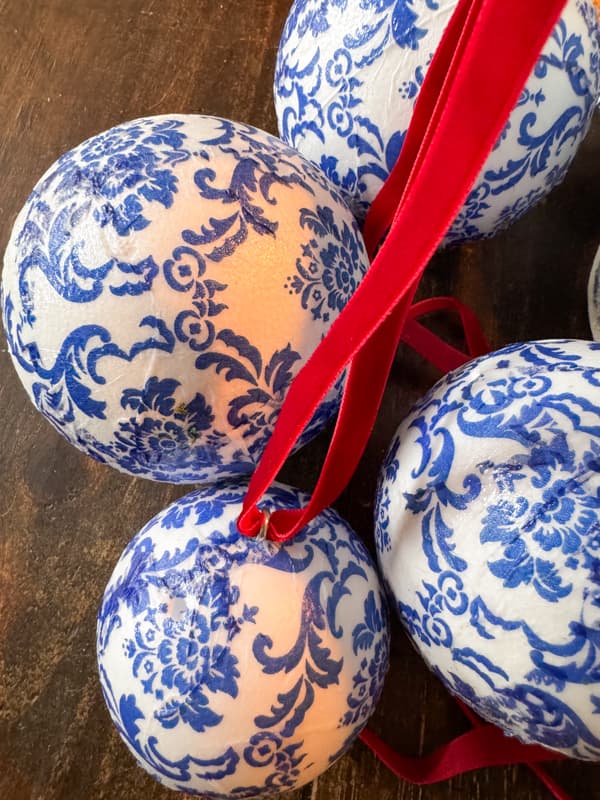 Blue and white napkin decoupage styrofoam balls repurposed as Christmas Tree Ornaments.