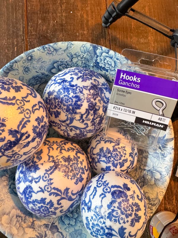 Blue and white napkin decoupage styrofoam balls repurposed as Christmas Tree Ornaments.