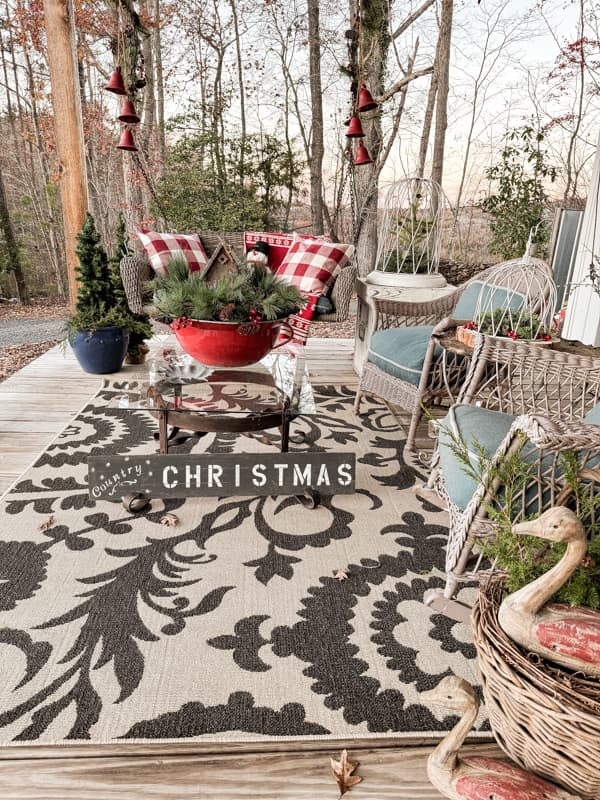 Black and Beige Rug anchors the seating area filled with outdoor Christmas Decorating Ideas