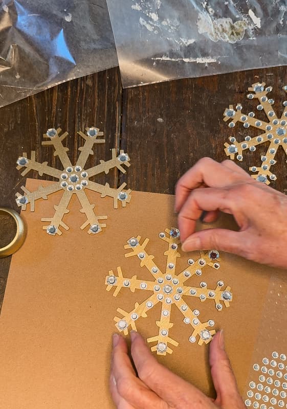 Adding rhinestone designs to Dollar Tree Christmas Snowflake ornaments