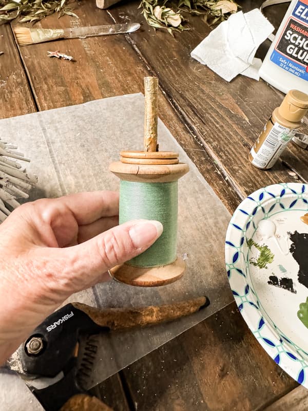 Use a vintage thread spool for the DIY Twig Christmas Tree