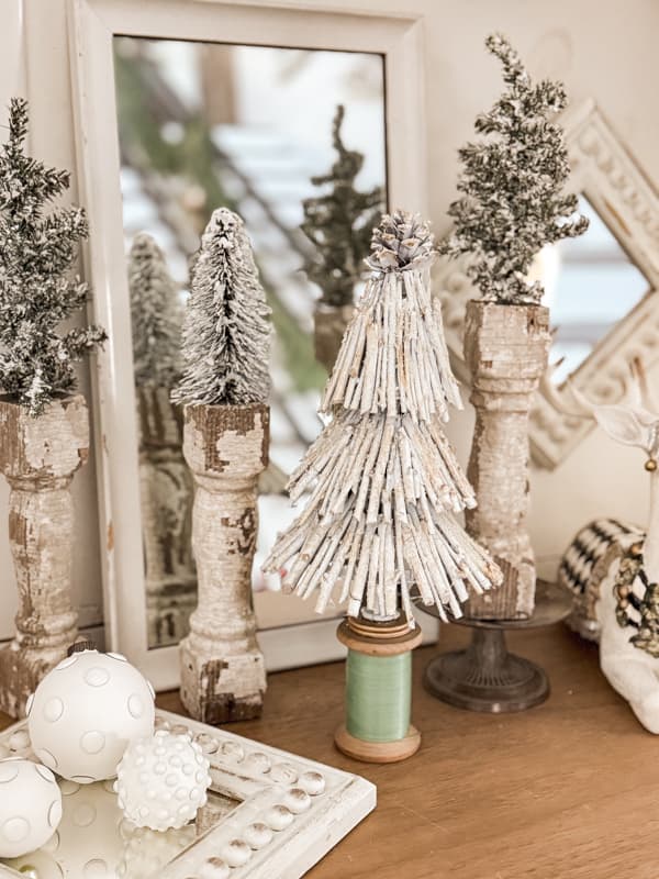 DIY Twig Christmas Tree with trees on architectural salvage bases on entry table