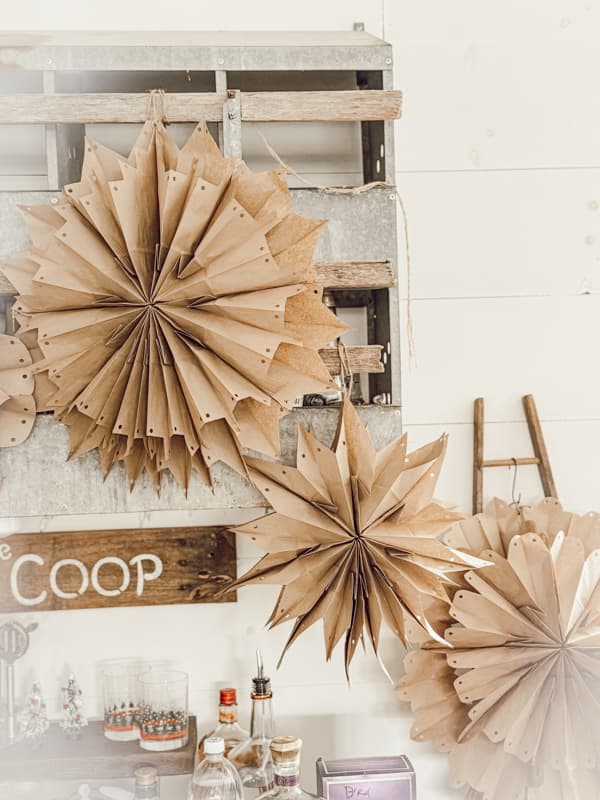 3-D Snowflakes are hanging from the nesting box over the farmhouse loft bar.  