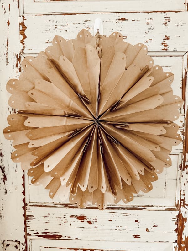 Brown kraft paper bag snowflake on vintage door.  