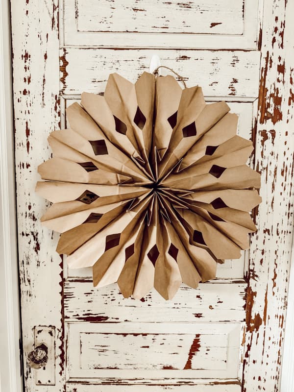 Brown kraft paper bag snowflake on vintage door