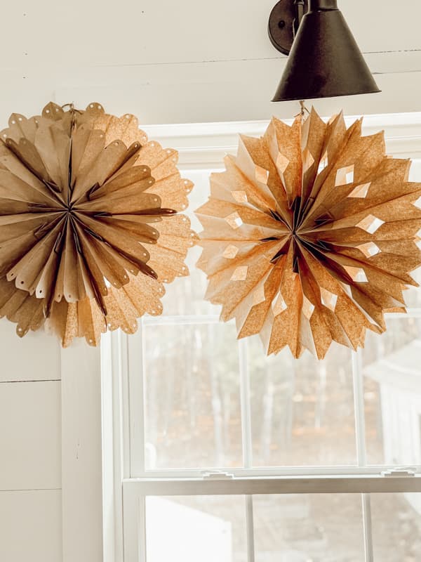 Paper Bag Snowflakes over loft window in farmhouse.  