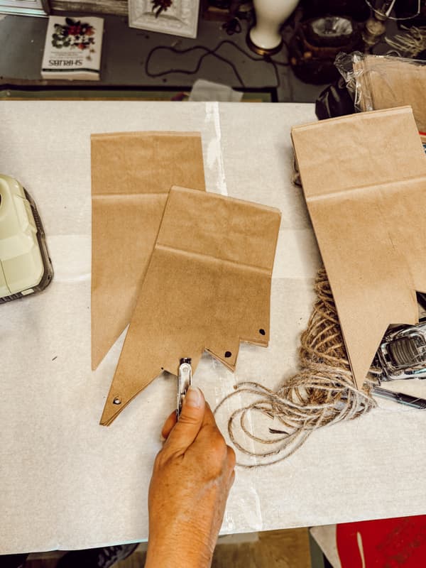 Pointed Snowflake design on brown paper bag with hold punch