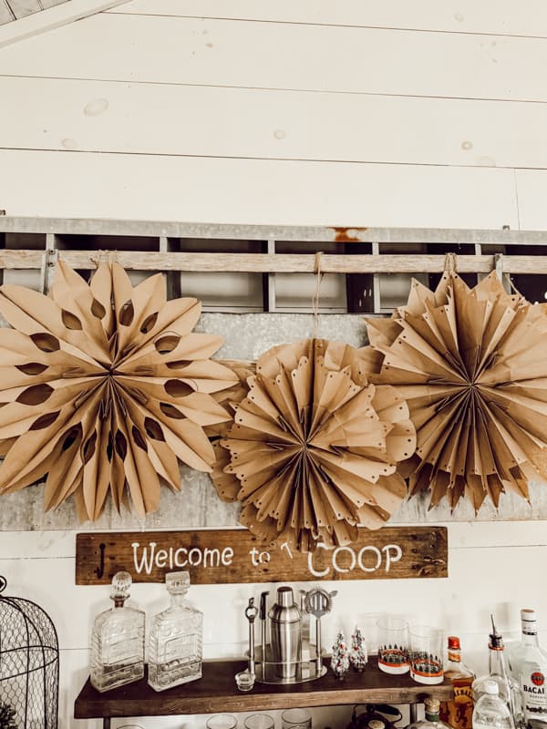 Paper Bag Snowflakes made with brown lunch bags on loft bar.  