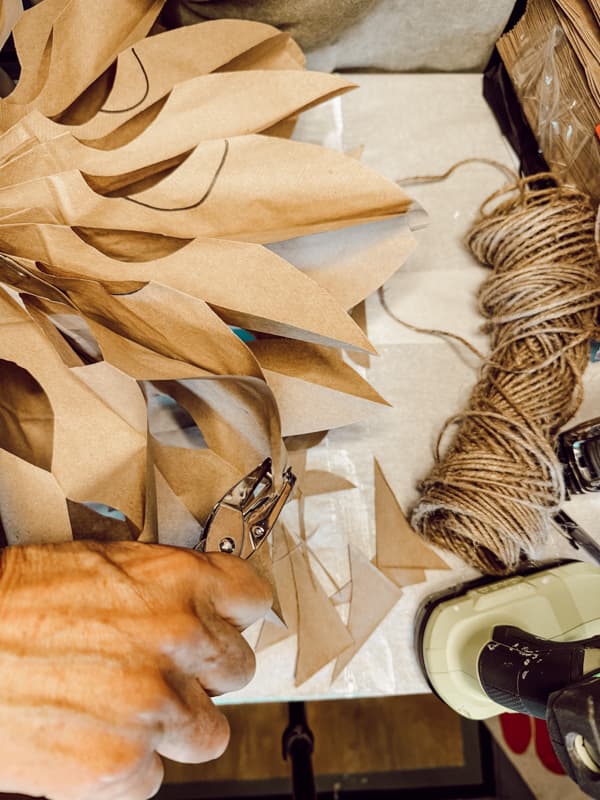 Punch hole in paper bag snowflakes