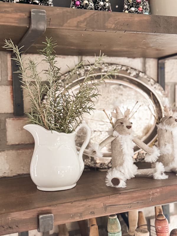 add fresh herbs to vintage ironstone pitch on open kitchen shelf.