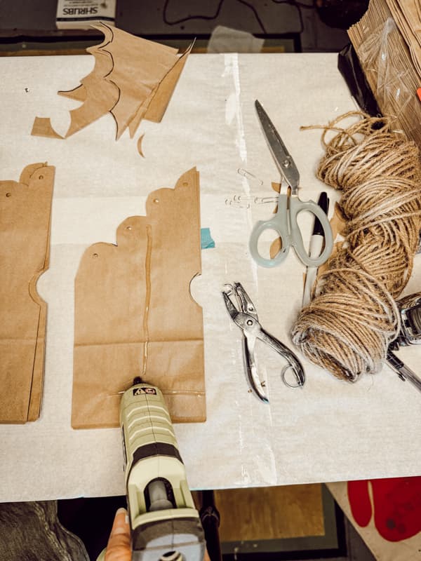 Add hot glue to paper bag to create DIY 3 -D Snowflakes 