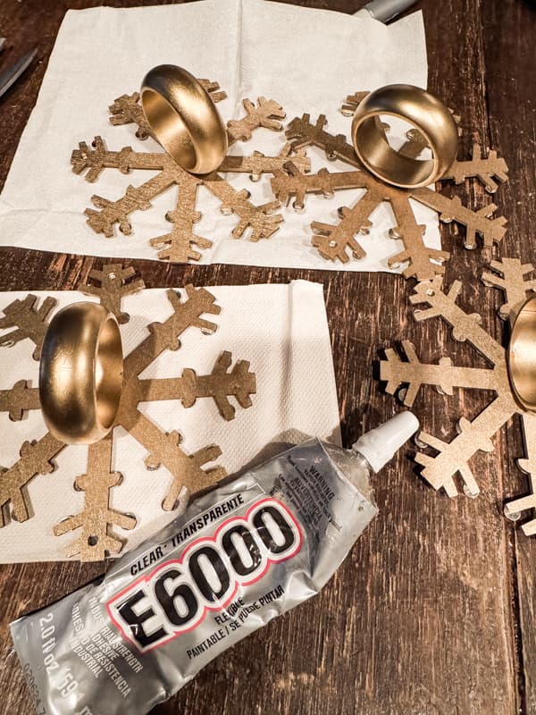 Add thrift store napkin rings to the Dollar Tree snowflakes with glue.